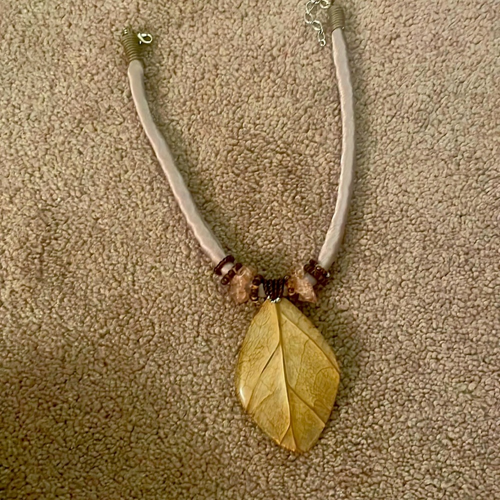 Leaf necklace with purple link and some gems